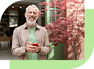 Man-Smartphone-Tea-Green-AdobeStock_528117170