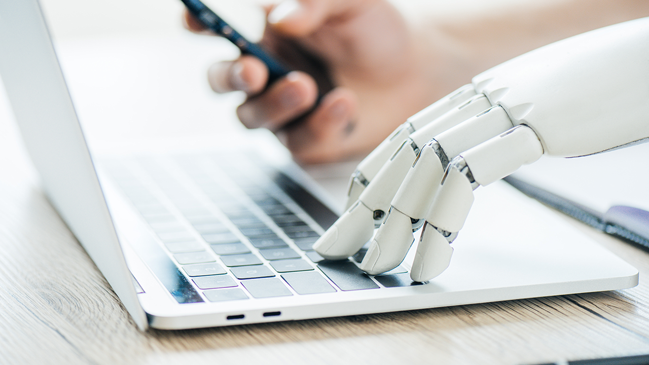 robot-and-human-on-keyboard-heading